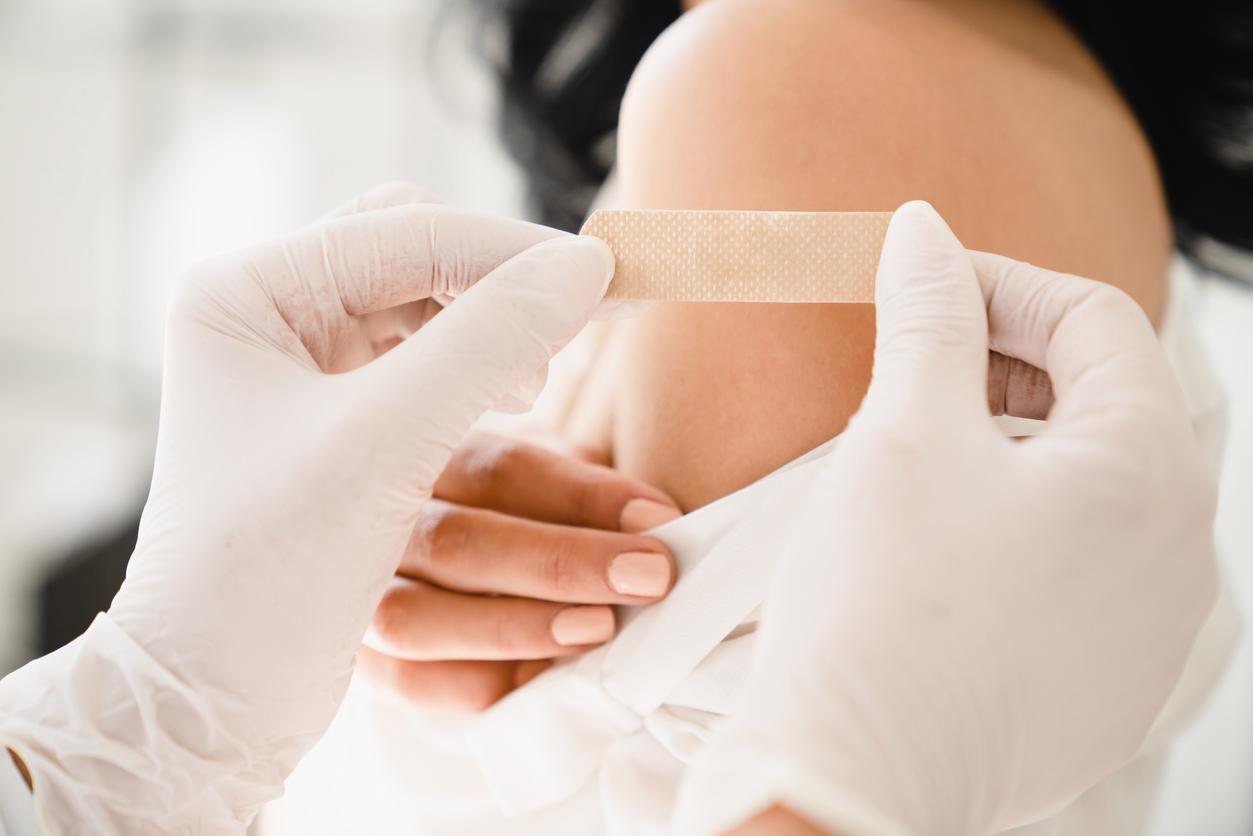 Young woman with bandaid on arm