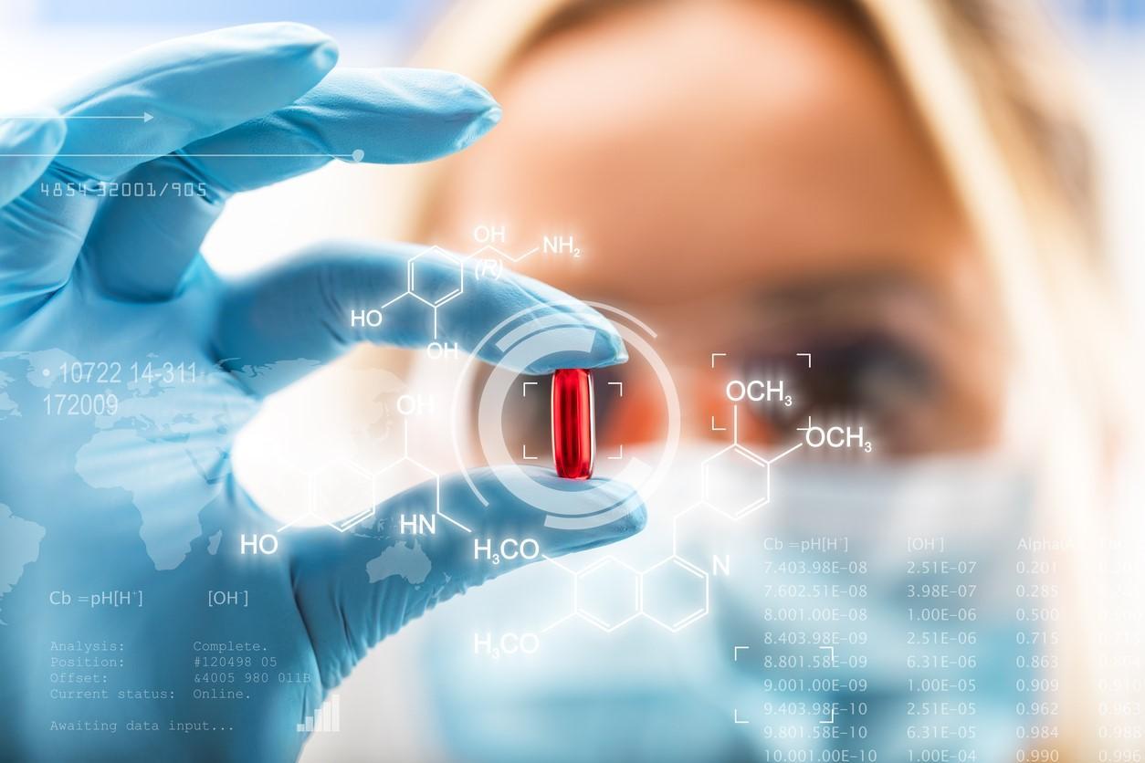 Drug researcher with pill