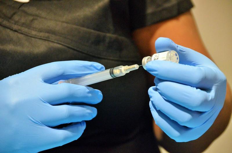 health worker drawing vaccine