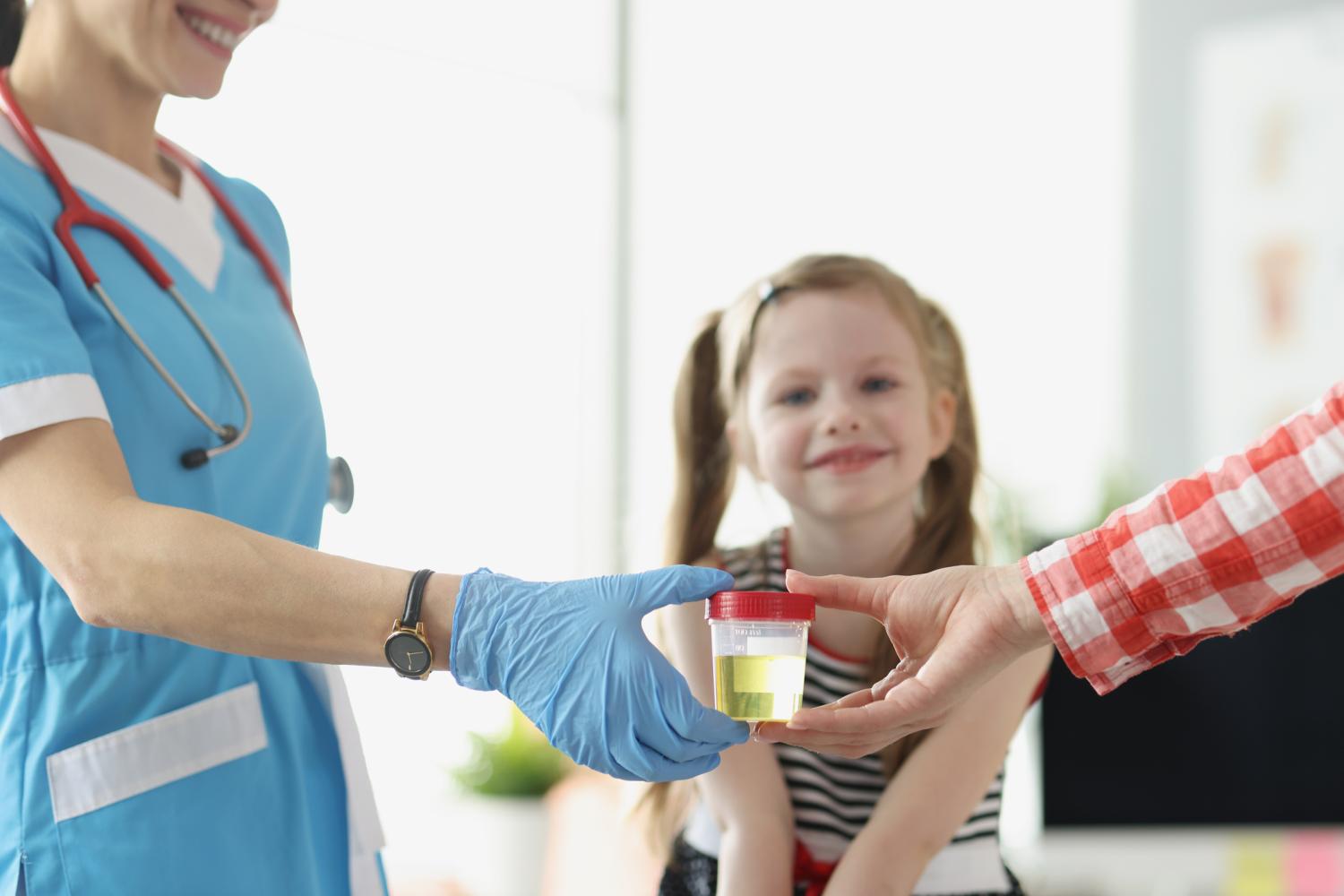 Mother and child with doctor and urine sample