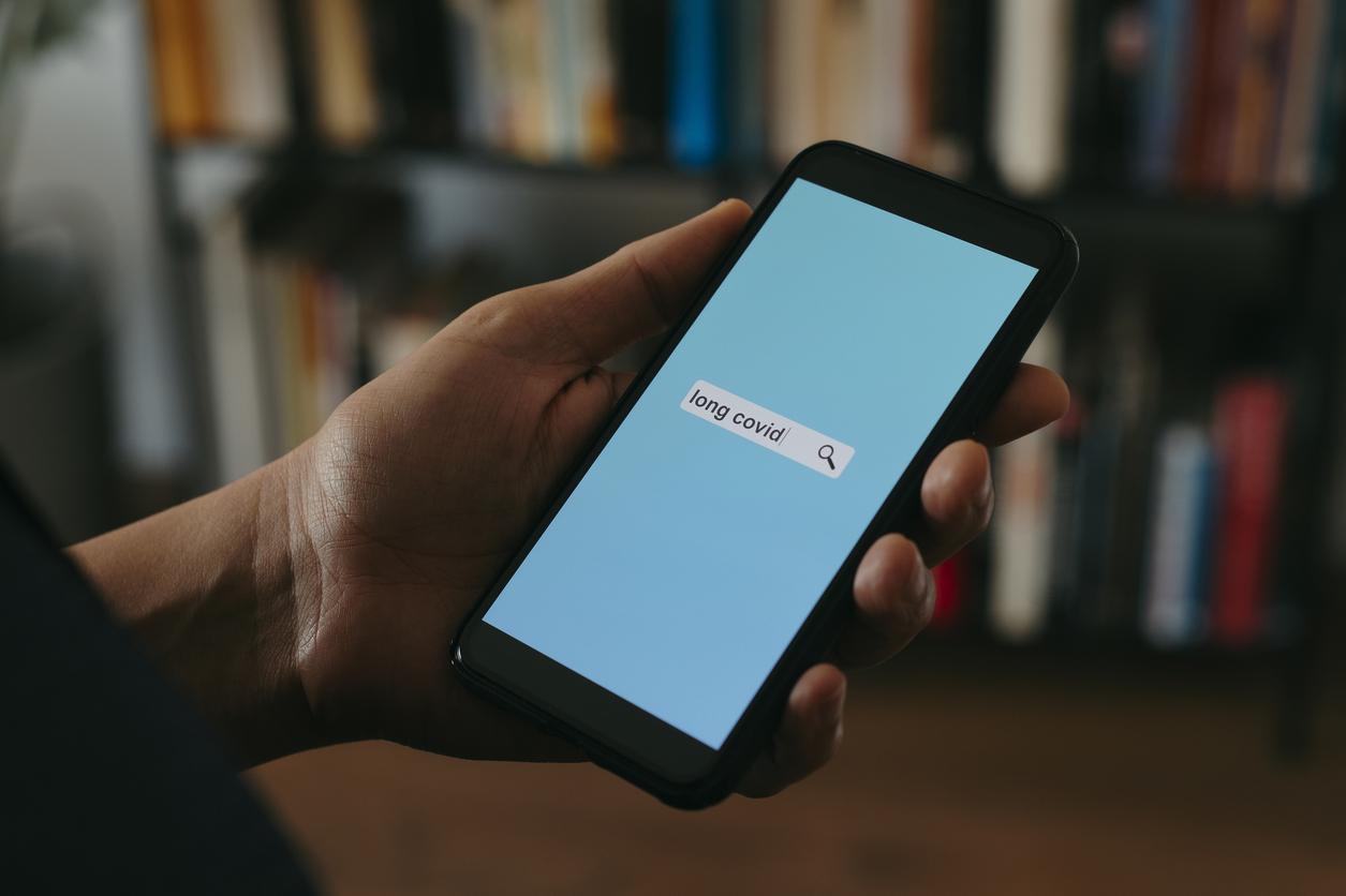 Person looking up long COVID on phone