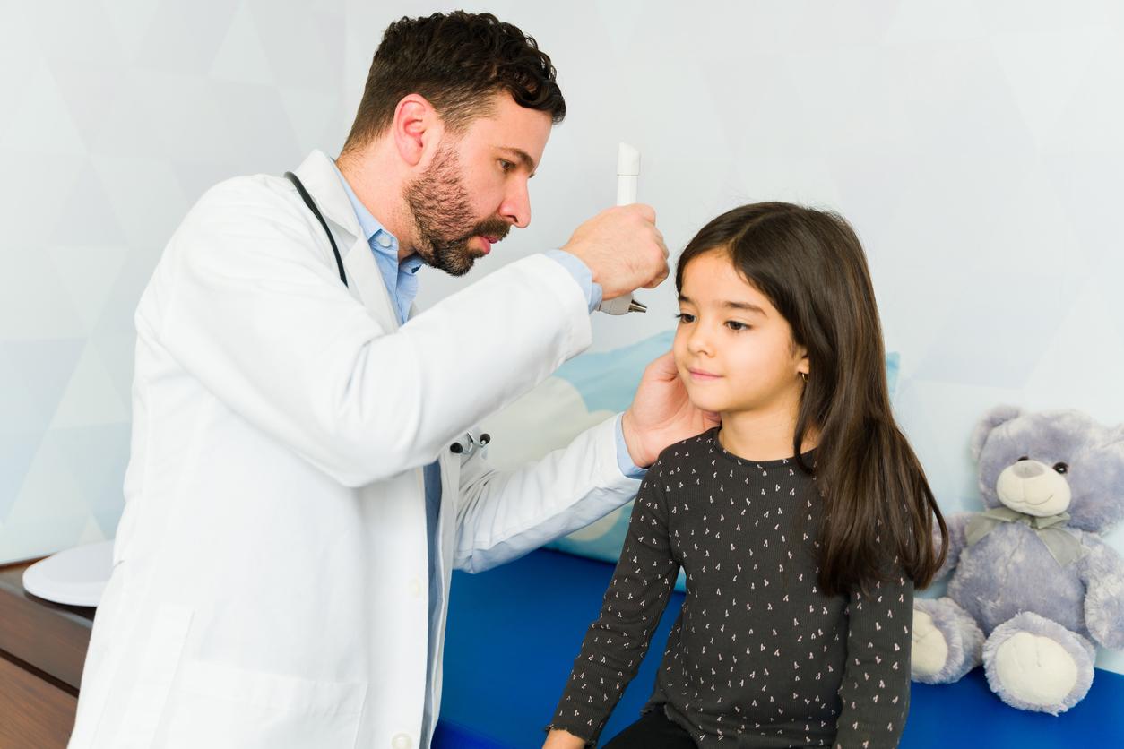 Doctor examining child's ears