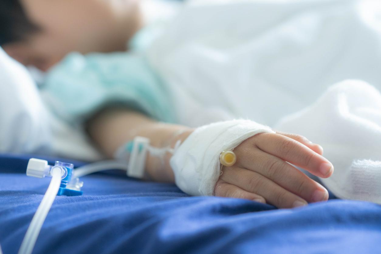 Sick child in hospital bed