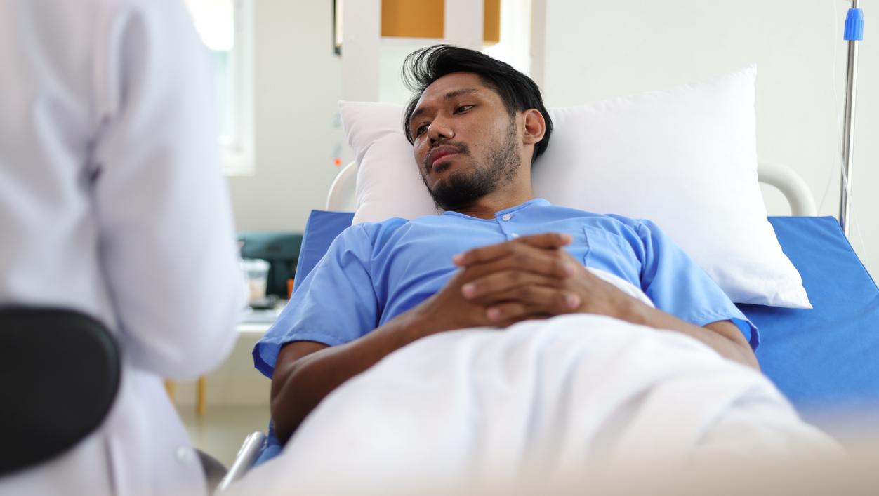 Asian man in hospital bed