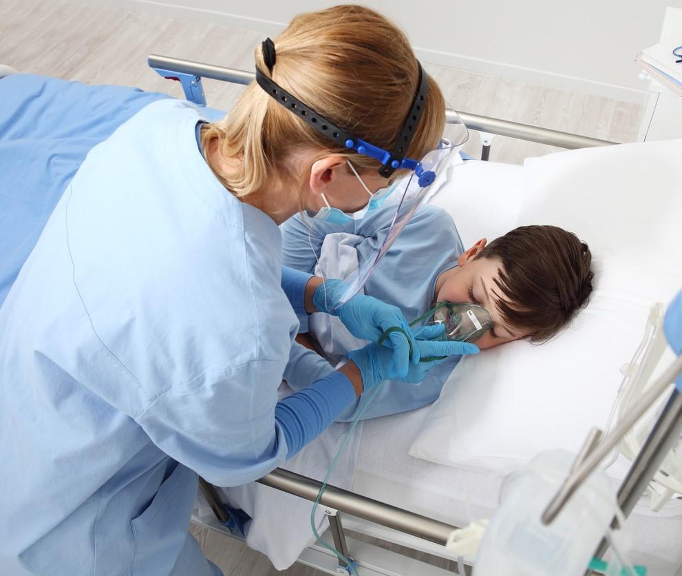 Nurse caring for young boy in hospital