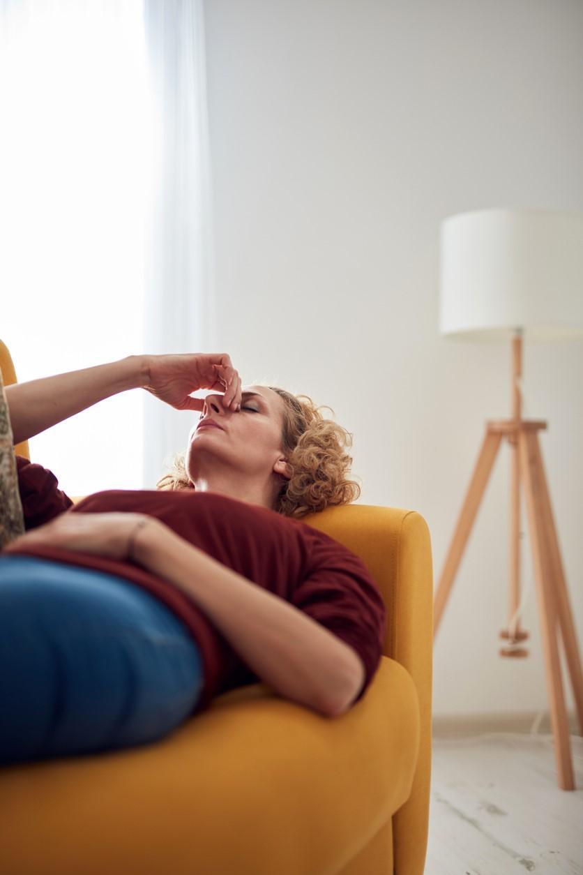 Woman with long COVID on couch