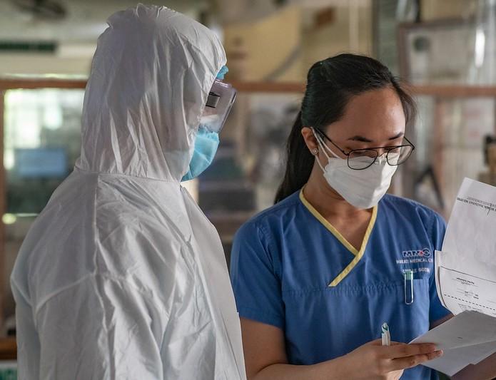 Two healthcare workers wearing personal protective equipment