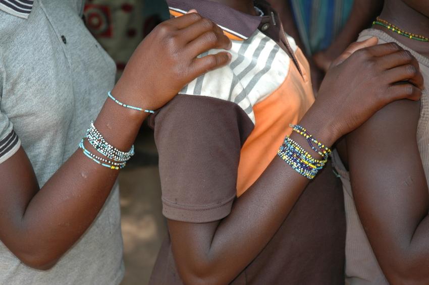 African girls with hands on one another's shoulders