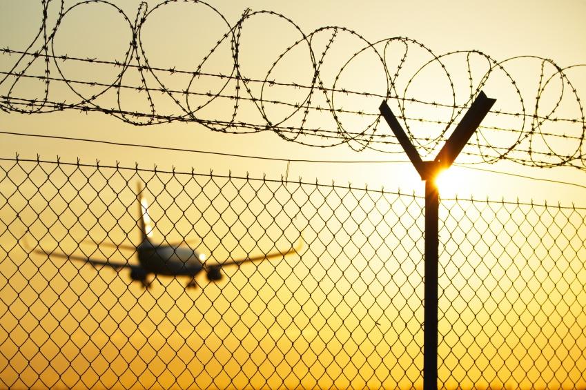 Airplane behind fence