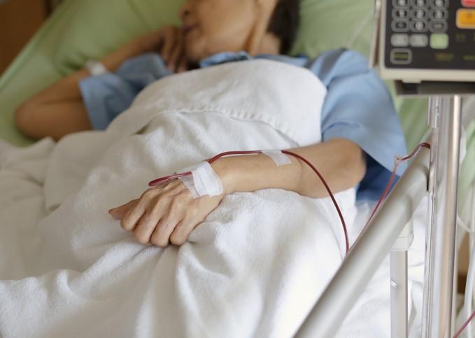 Asian man in hospital bed