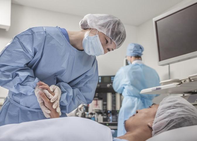 Asian surgeon with patient