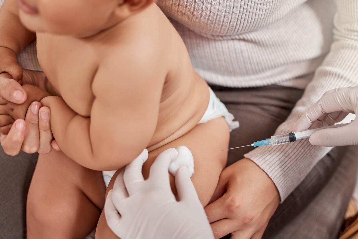 Baby getting vaccinated on mom's lap