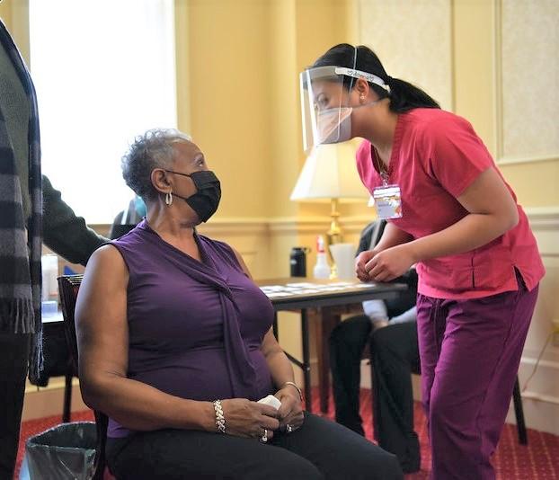 Woman getting prepped for COVID vaccine