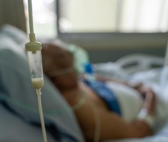 Older hospital patient on oxygen blurred