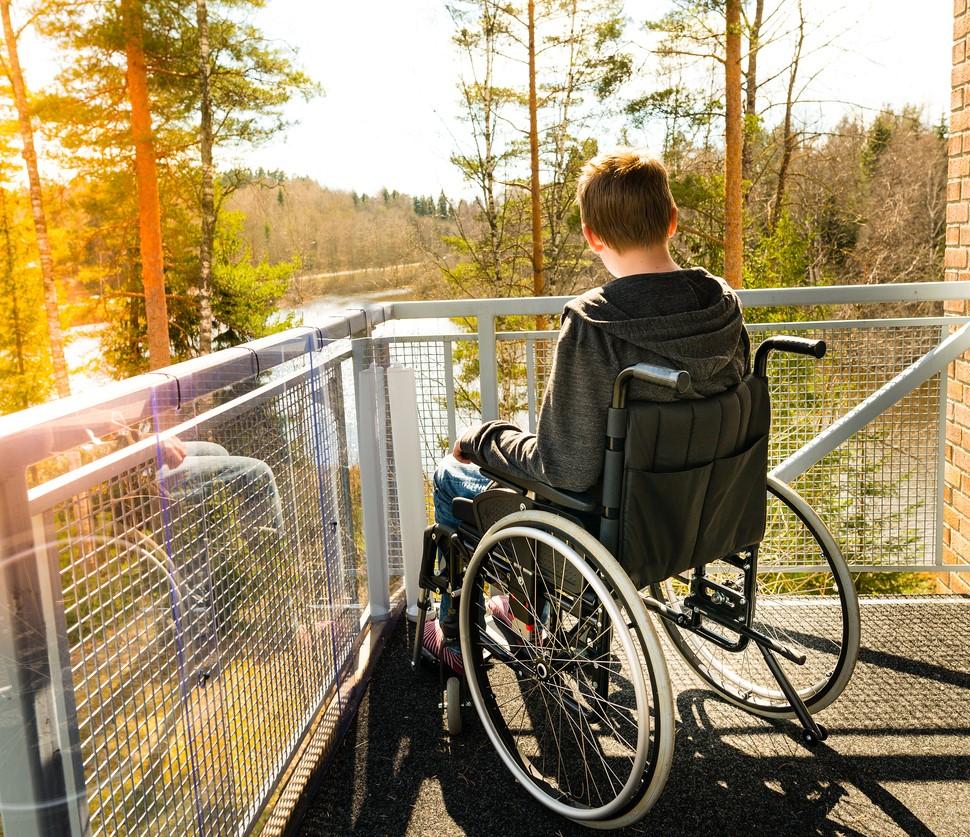 Boy in wheelchair on balcony
