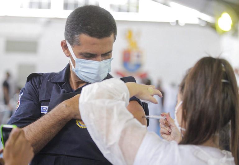 Brazilian police officer getting COVID vaccine