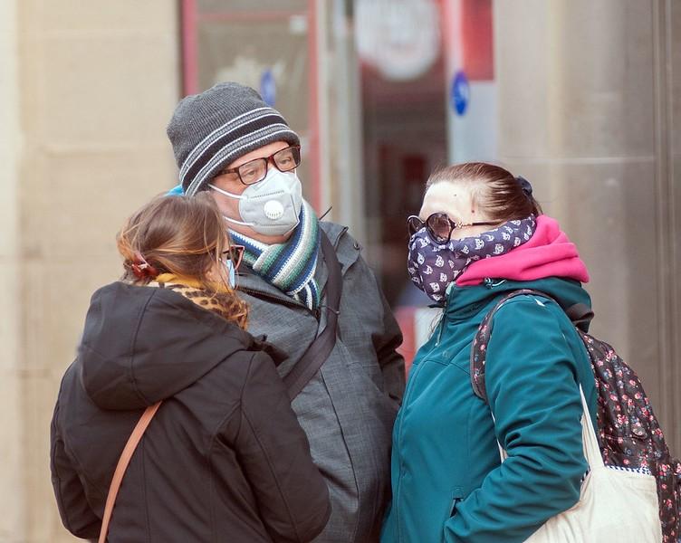 British pedestrians wearing medical masks