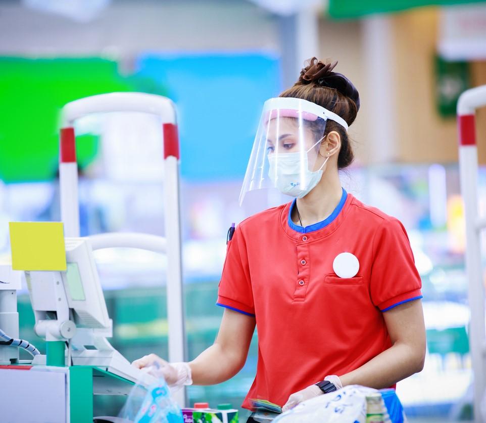 Cashier with mask and face shield