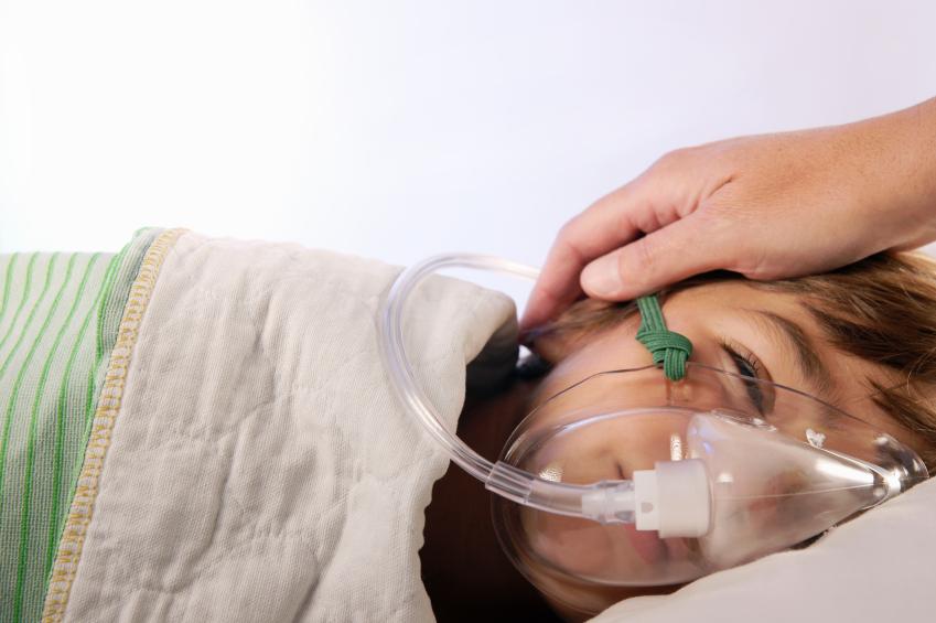 Sick child wearing oxygen mask