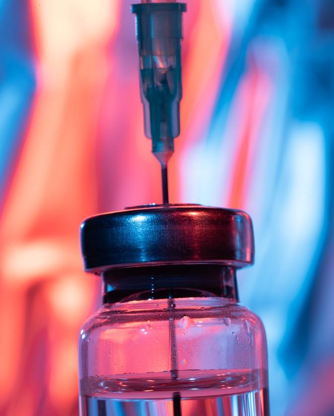 Close-up of needle inserted into vial
