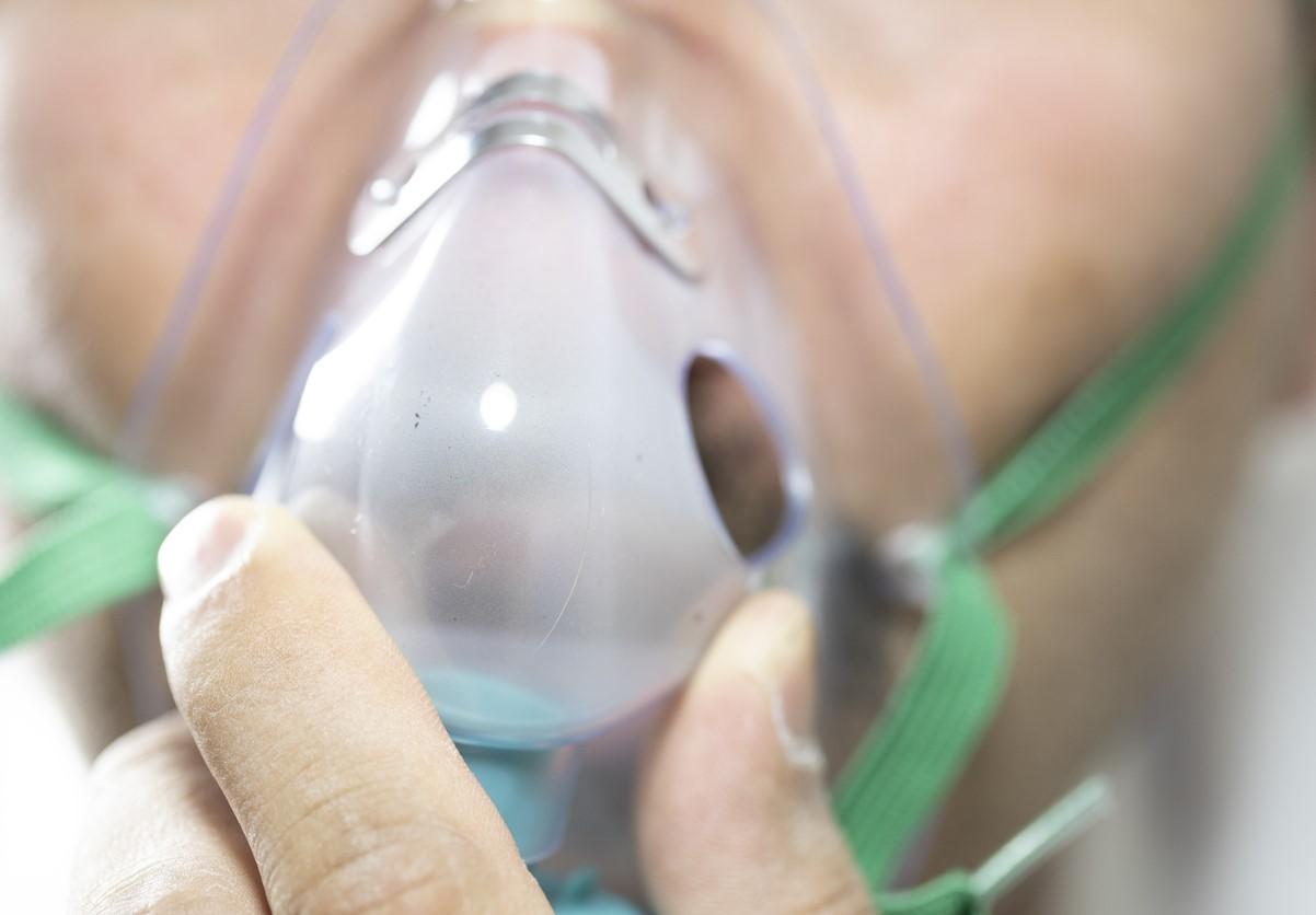 Close-up of large man with oxygen mask