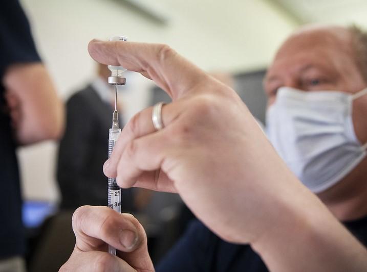 Vaccinator with syringe in foreground