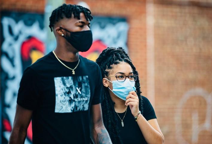Man and woman wearing masks
