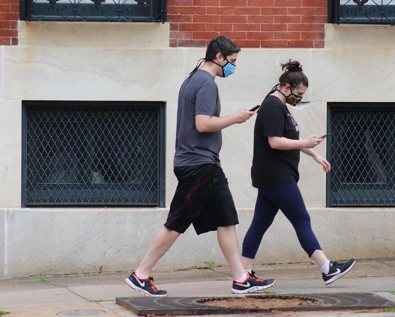 Couple wearing masks walking on street