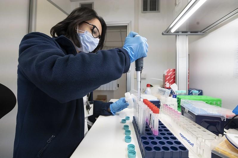 COVID-19 lab researcher pipetting