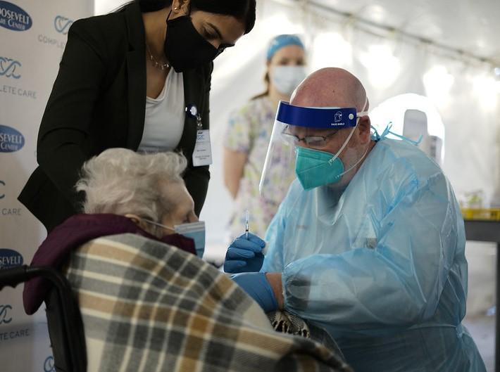 Elderly woman receiving COVID vaccine
