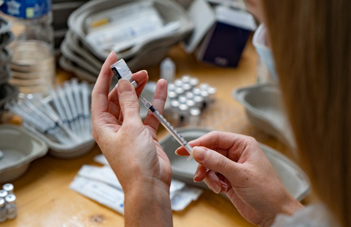 COVID vaccinator with syringes
