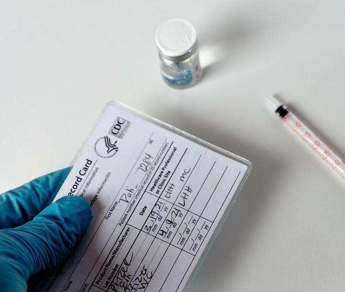 COVID vaccine card, vial, syringe