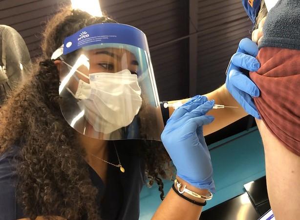 COVID vaccine needle going into arm