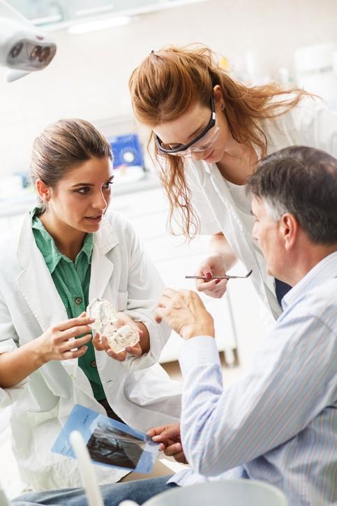 Dentist and assistant with patient