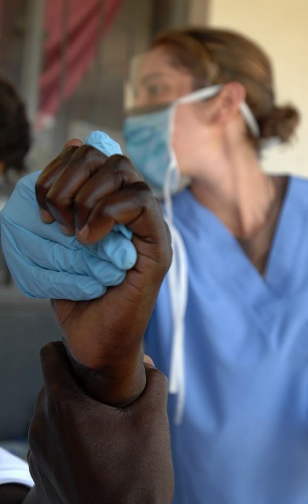 Doctor holding patient's hand