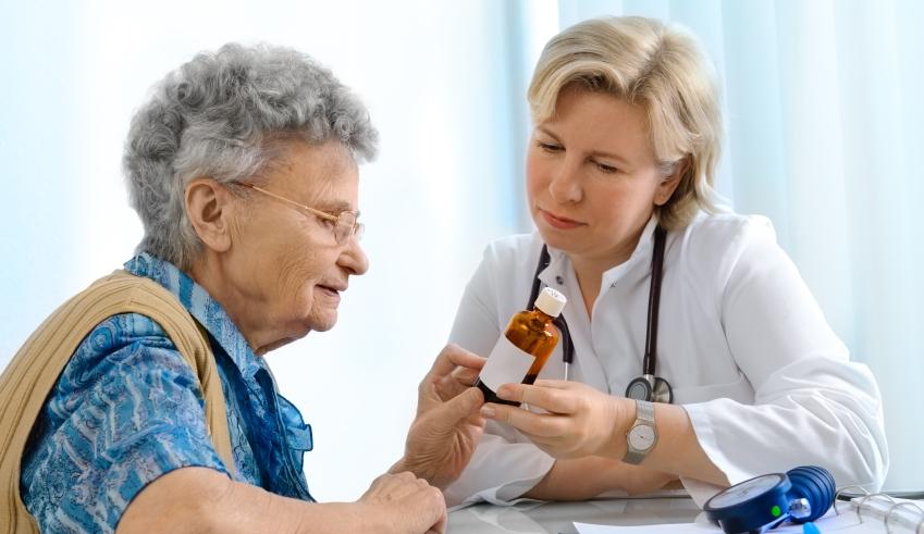 Doctor explaining dosage to elderly patient