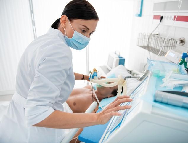 Doctor wearing surgical mask at bedside