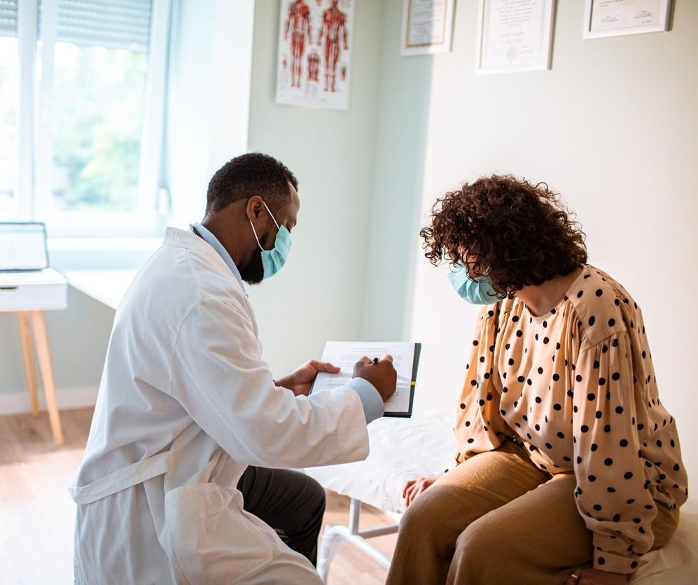 Doctor with patient, both wearing masks