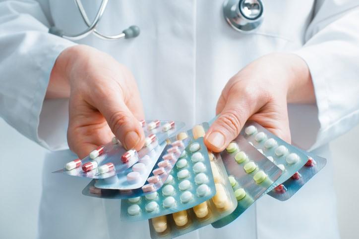 Doctor with packs of pills