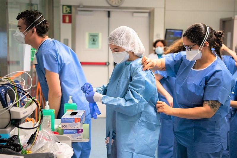 Hospital workers donning PPE