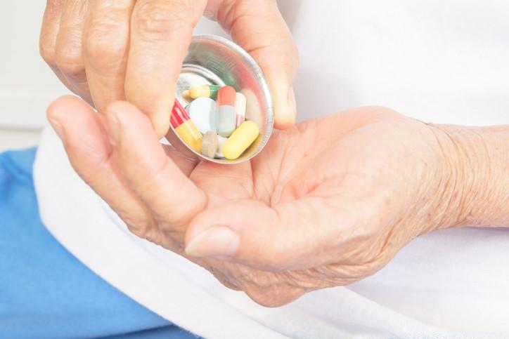 Drugs in hand of older woman