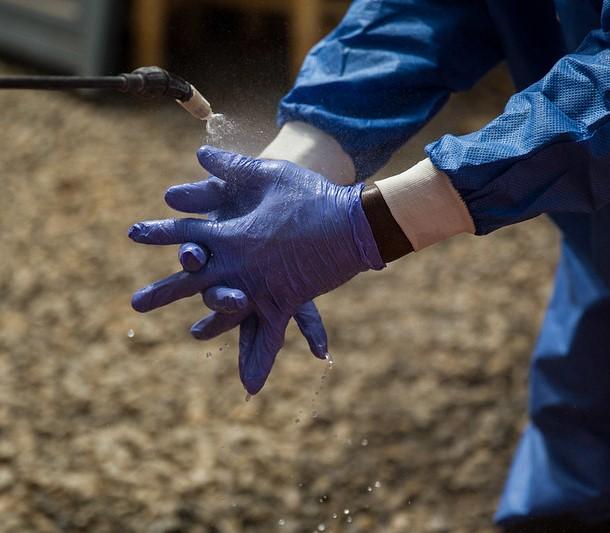 Ebola worker washing gloves