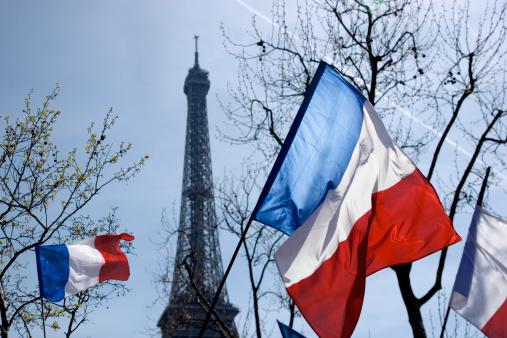 French flags in front of Eiffel Tower