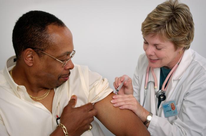 Person receiving flu shot.
