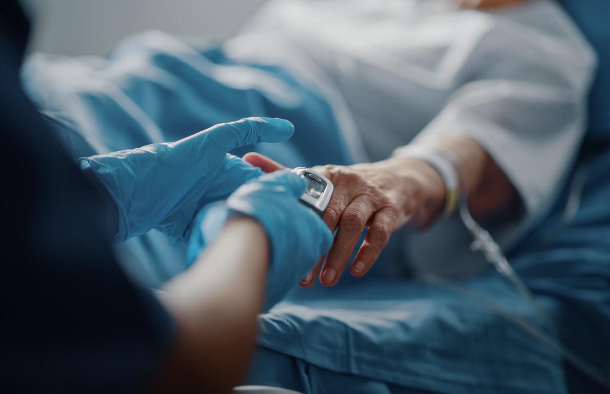 Older hospital patient with pulse oximeter on finger