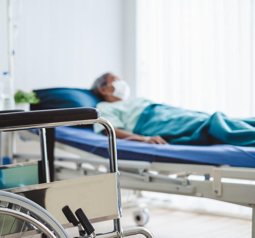 Elderly man in hospital bed