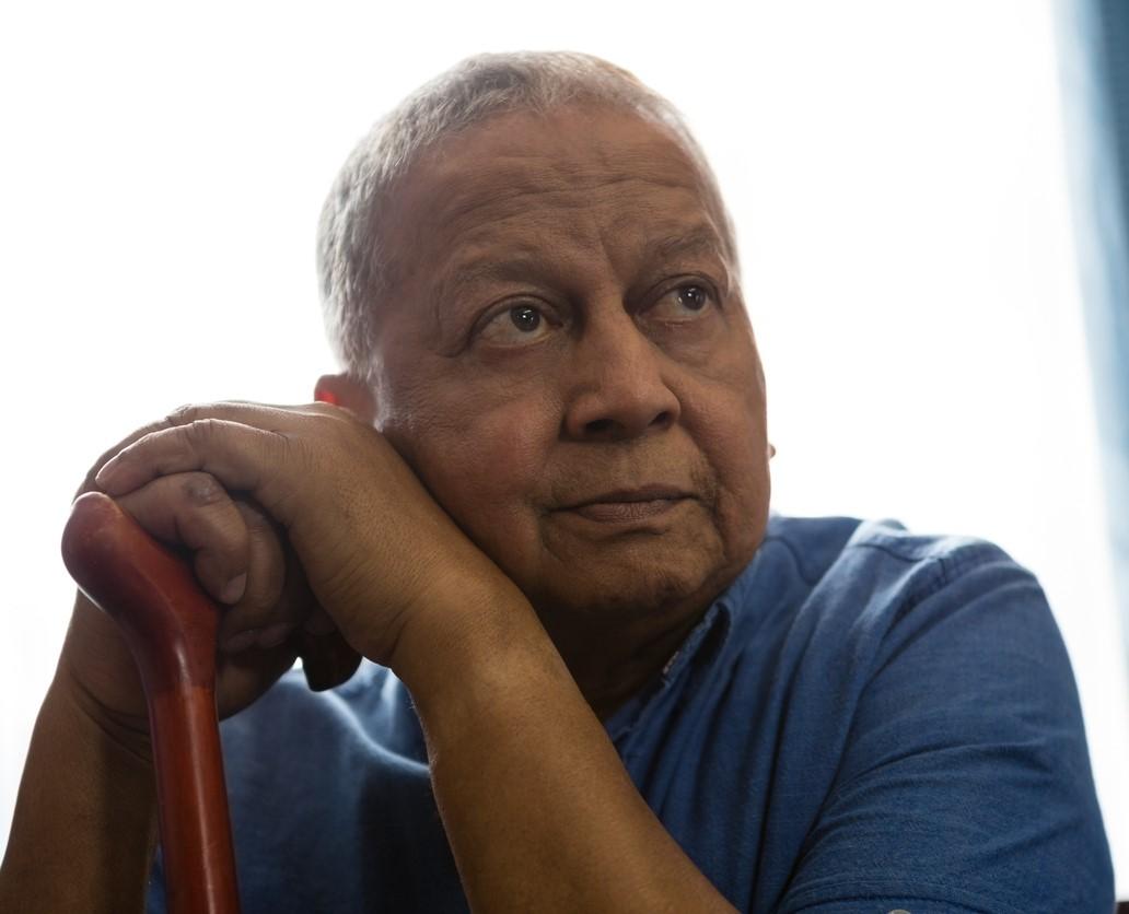 Elderly man leaning on cane