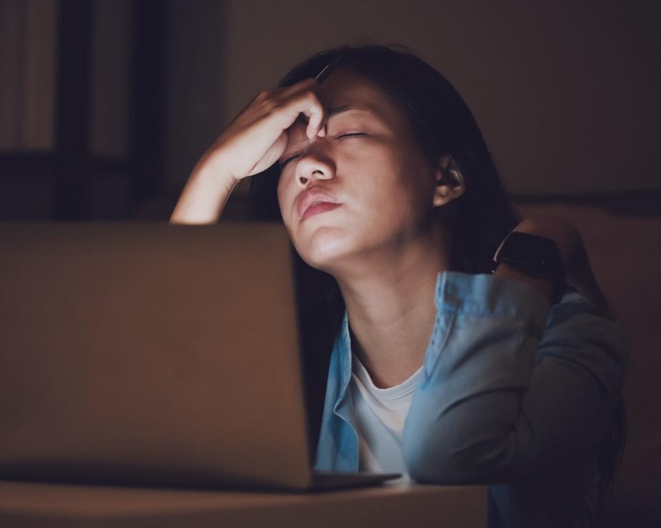 Exhausted woman at computer