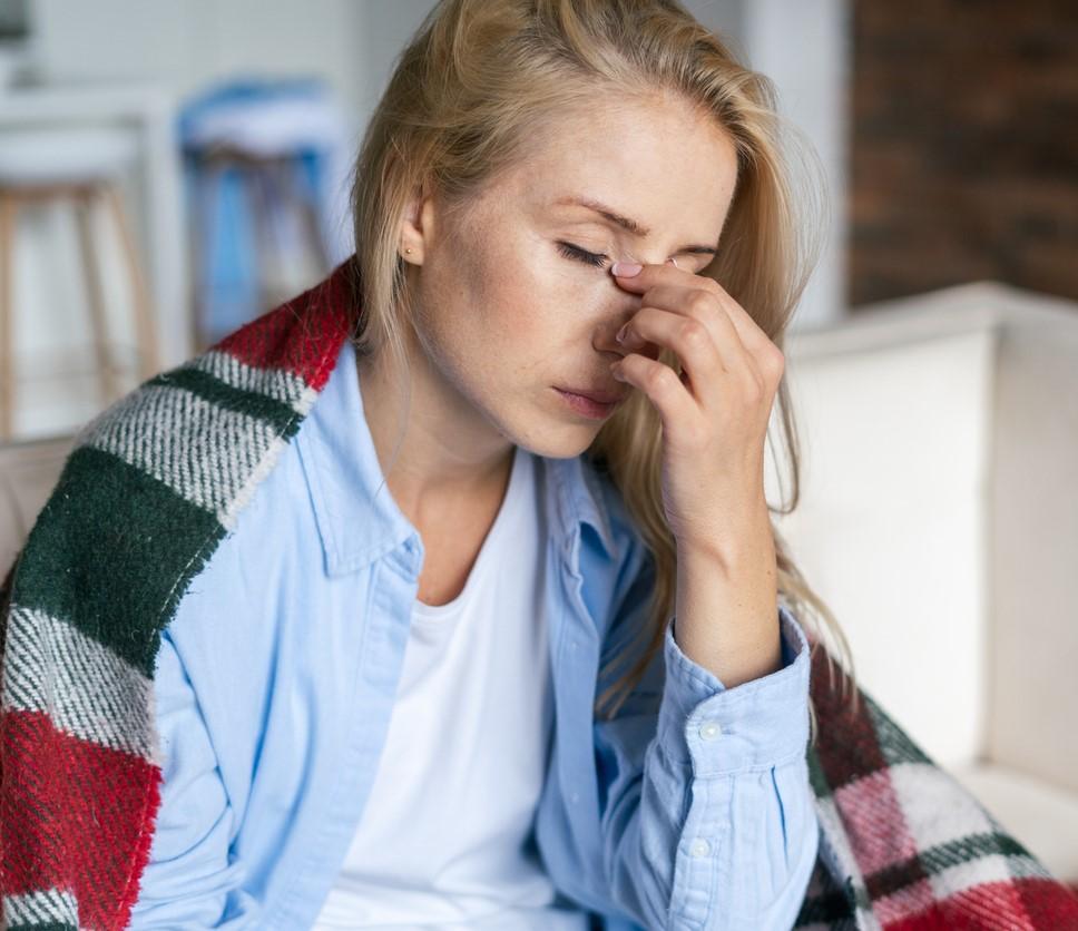 Exhausted woman draped in blanket