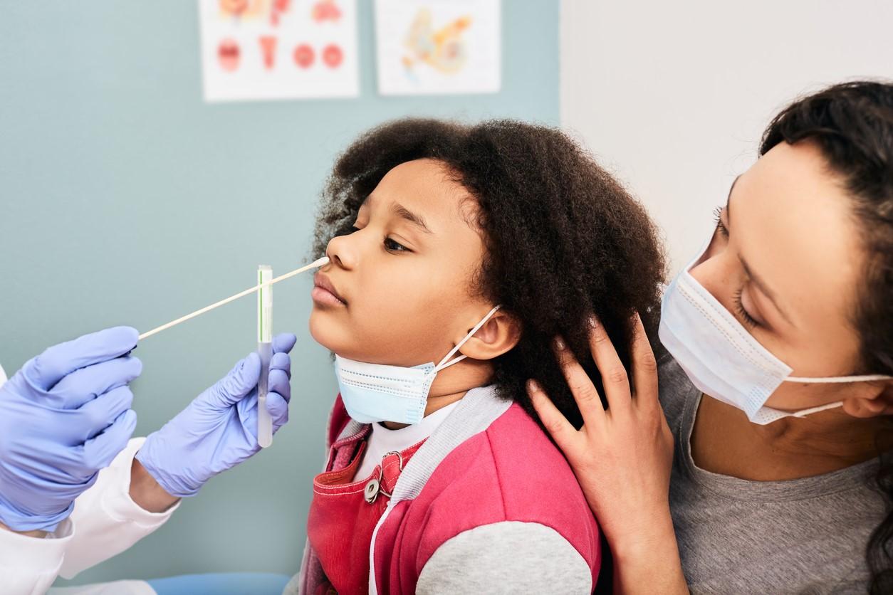 Girl getting nose swabbed COVID test